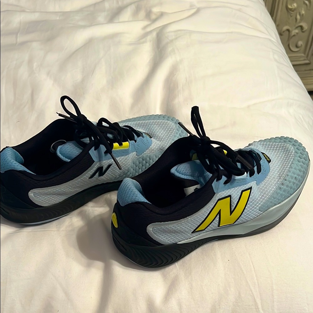 New Balance Fuel Cell 966 tennis shoe. Light blue with yellow N. Size 7 1/2. W